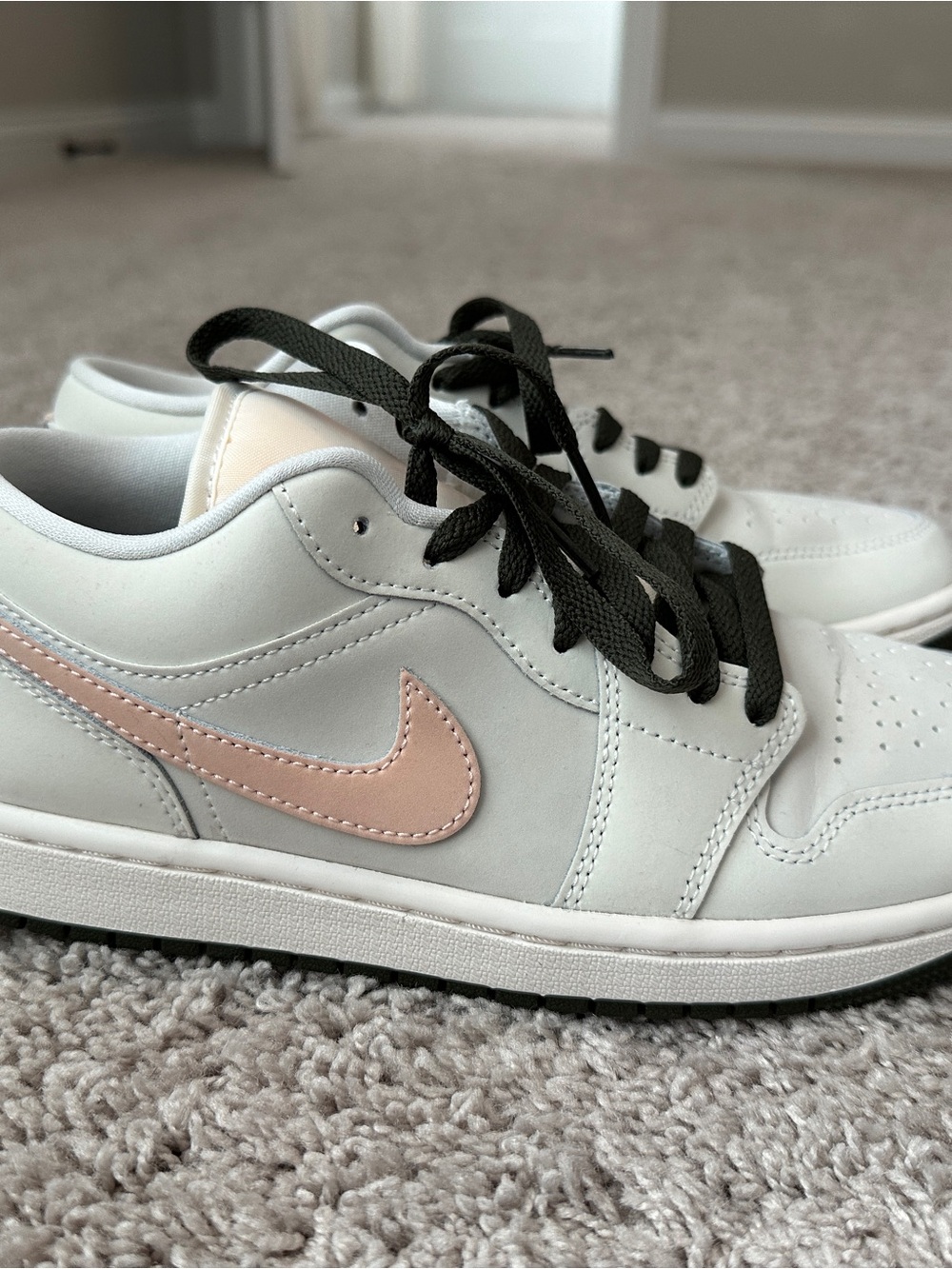 Nike White Low-Top Sneakers with Pale Pink Swoosh and Black Laces